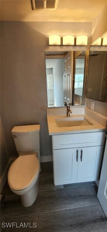 548 Broad Ave S Unit 548, Naples, FL 34102 - bathroom with vanity, toilet, and baseboards