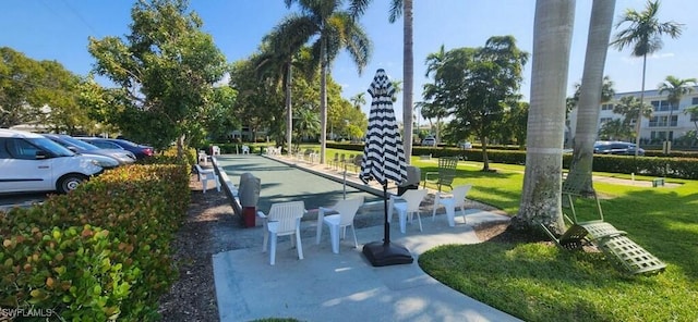 548 Broad Ave S Unit 548, Naples, FL 34102 - surrounding community with a bocce ball area, a lawn, and uncovered parking