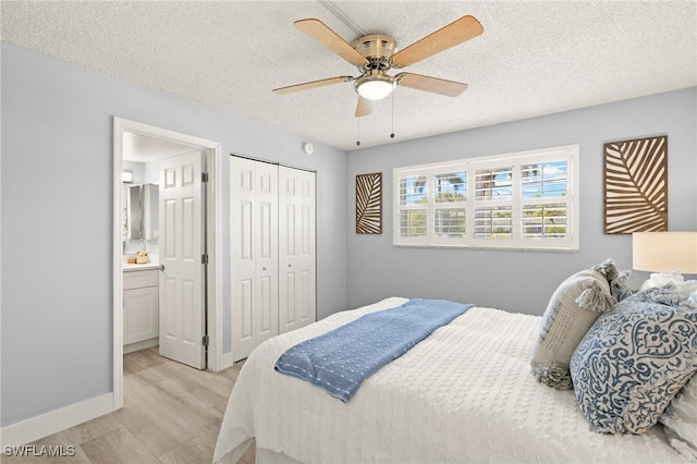 548 Broad Ave S Unit 548, Naples, FL 34102 - bedroom featuring light wood-style flooring, a textured ceiling, a closet, a ceiling fan, and ensuite bath