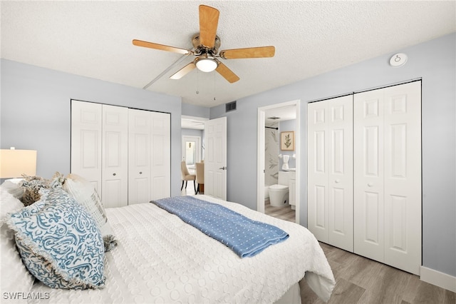 548 Broad Ave S Unit 548, Naples, FL 34102 - bedroom featuring wood finished floors, ensuite bathroom, a ceiling fan, and a textured ceiling