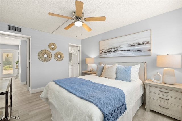 548 Broad Ave S Unit 548, Naples, FL 34102 - bedroom featuring light wood-style floors, baseboards, a textured ceiling, and ceiling fan