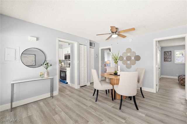 548 Broad Ave S Unit 548, Naples, FL 34102 - dining space with light wood-style floors, a ceiling fan, a textured ceiling, and baseboards