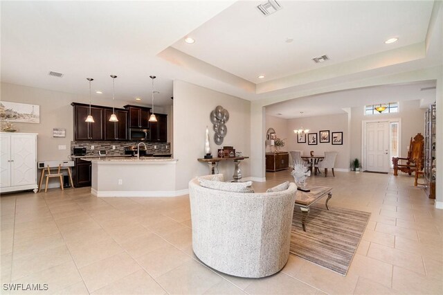 3130 Scarlet Oak Pl, North Fort Myers, FL 33903 - living area featuring light tile patterned flooring, recessed lighting, a raised ceiling, and a chandelier