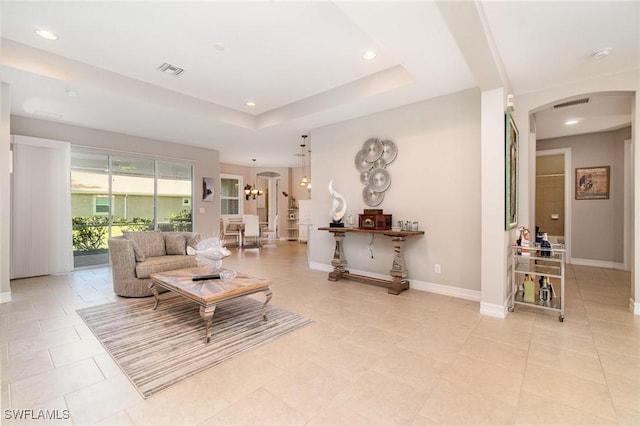 3130 Scarlet Oak Pl, North Fort Myers, FL 33903 - living area with arched walkways, a tray ceiling, recessed lighting, and light tile patterned flooring