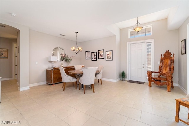 3130 Scarlet Oak Pl, North Fort Myers, FL 33903 - dining room with arched walkways, a chandelier, and light tile patterned flooring