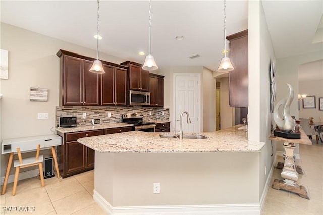 3130 Scarlet Oak Pl, North Fort Myers, FL 33903 - kitchen featuring stainless steel appliances, light tile patterned floors, decorative backsplash, dark brown cabinetry, and light stone counters