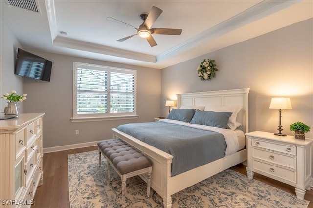 6848 Winding Cypress Dr, Naples, FL 34114 - bedroom with a raised ceiling, dark wood-style floors, crown molding, baseboards, and ceiling fan
