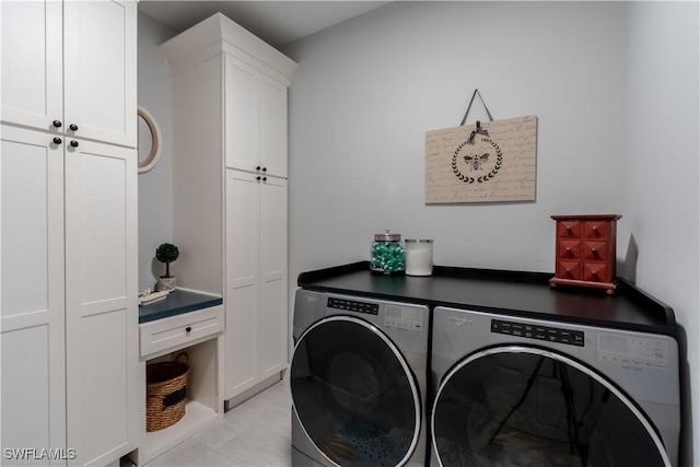 6848 Winding Cypress Dr, Naples, FL 34114 - washroom with washing machine and clothes dryer, cabinet space, and light tile patterned floors