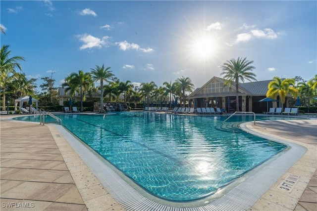 6848 Winding Cypress Dr, Naples, FL 34114 - community pool with a patio area