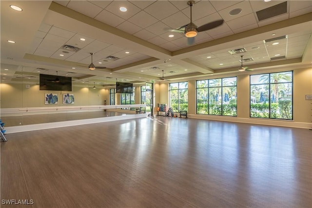 6848 Winding Cypress Dr, Naples, FL 34114 - workout room featuring ceiling fan, wood finished floors, baseboards, recessed lighting, and a tray ceiling