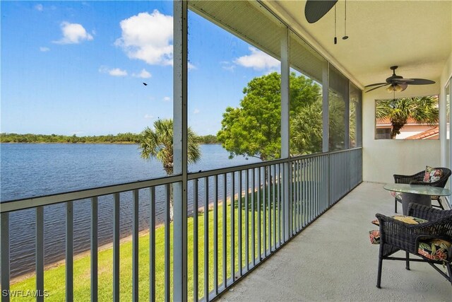 25057 Peacock Ln Unit 202, Naples, FL 34114 - balcony with a ceiling fan and a water view