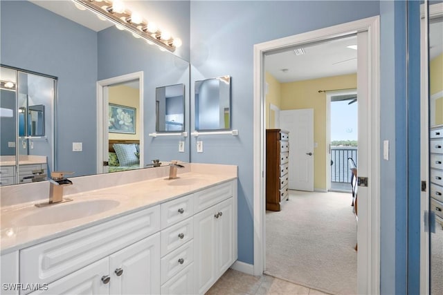 25057 Peacock Ln Unit 202, Naples, FL 34114 - bathroom with double vanity and baseboards