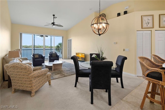 25057 Peacock Ln Unit 202, Naples, FL 34114 - dining space with a chandelier, ceiling fan, light colored carpet, high vaulted ceiling, and baseboards