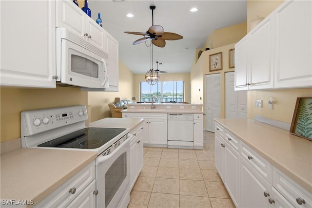 25057 Peacock Ln Unit 202, Naples, FL 34114 - kitchen with white appliances, lofted ceiling, ceiling fan, light countertops, and white cabinets