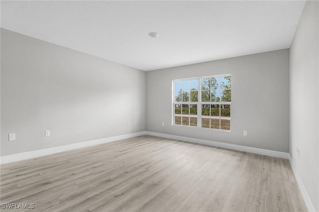 365 Woodburn Dr, Lehigh Acres, FL 33972 - unfurnished room featuring light wood-style floors and baseboards