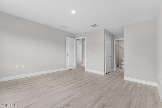 365 Woodburn Dr, Lehigh Acres, FL 33972 - unfurnished bedroom with light wood-style flooring, baseboards, connected bathroom, and recessed lighting