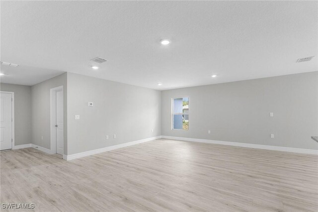 365 Woodburn Dr, Lehigh Acres, FL 33972 - empty room featuring light wood-style floors, baseboards, and recessed lighting