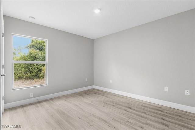 365 Woodburn Dr, Lehigh Acres, FL 33972 - unfurnished room featuring light wood-type flooring, baseboards, and a smoke detector