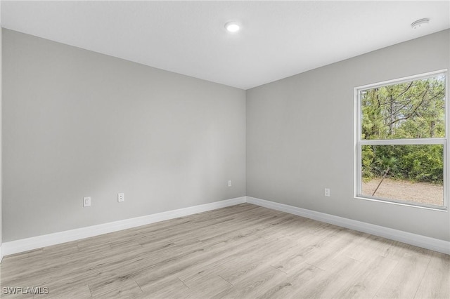 365 Woodburn Dr, Lehigh Acres, FL 33972 - unfurnished room with light wood-type flooring, baseboards, and a smoke detector