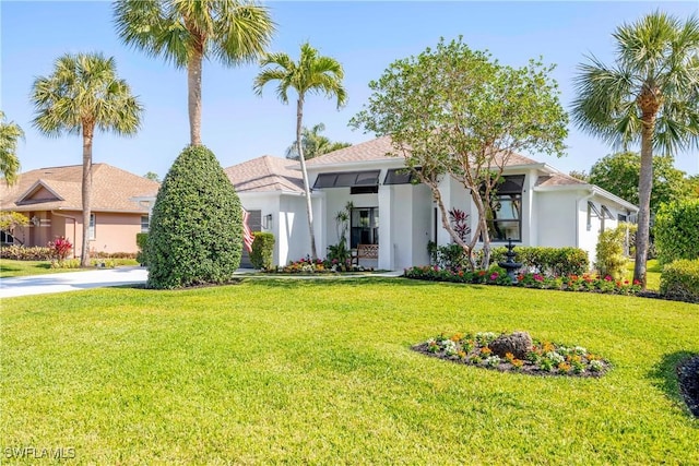 520 Raven Way, Naples, FL 34110 - view of front of home with stucco siding and a front yard