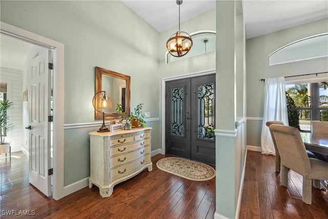 520 Raven Way, Naples, FL 34110 - entrance foyer featuring a chandelier, dark wood-type flooring, french doors, baseboards, and a towering ceiling
