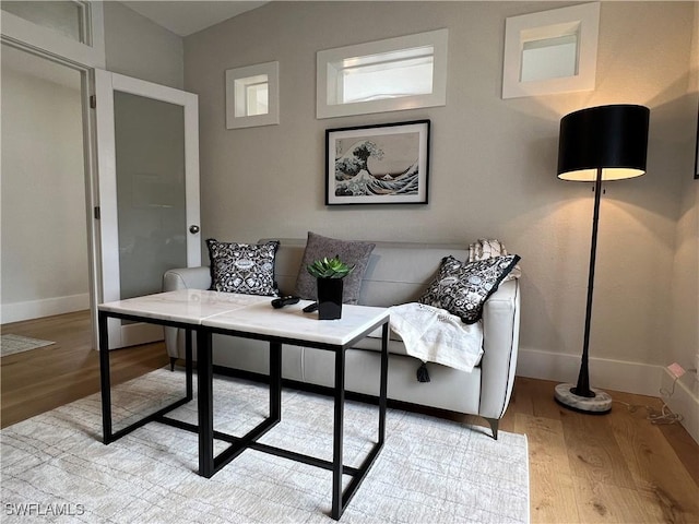 7087 Barrington Cir Unit 201, Naples, FL 34108 - living room featuring light wood finished floors and baseboards