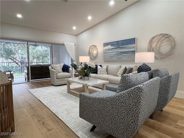 7087 Barrington Cir Unit 201, Naples, FL 34108 - living area featuring wood finished floors, vaulted ceiling, and recessed lighting