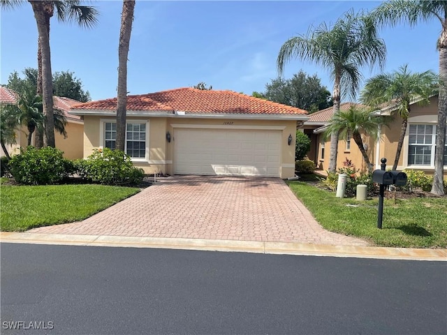 10427 Carolina Willow Dr, Fort Myers, FL 33913 - view of front of house with stucco siding, a garage, a tile roof, and decorative driveway