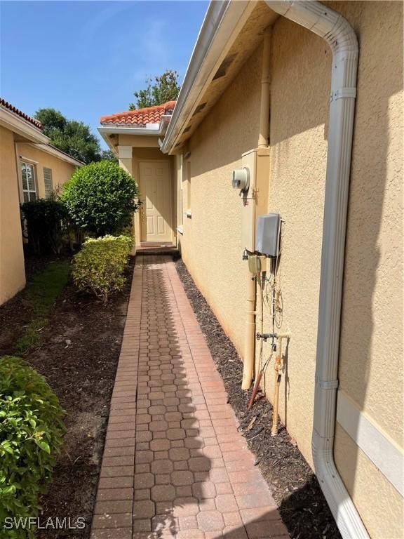 10427 Carolina Willow Dr, Fort Myers, FL 33913 - view of side of home featuring stucco siding