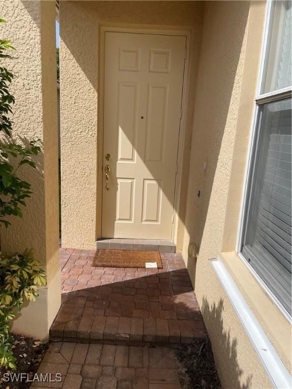 10427 Carolina Willow Dr, Fort Myers, FL 33913 - view of exterior entry with stucco siding