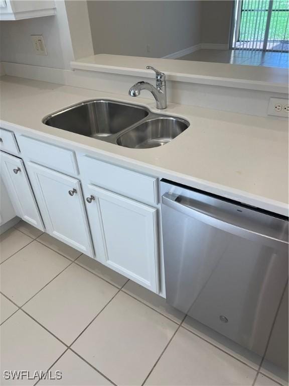 10427 Carolina Willow Dr, Fort Myers, FL 33913 - kitchen featuring stainless steel dishwasher, a sink, white cabinetry, and light tile patterned floors