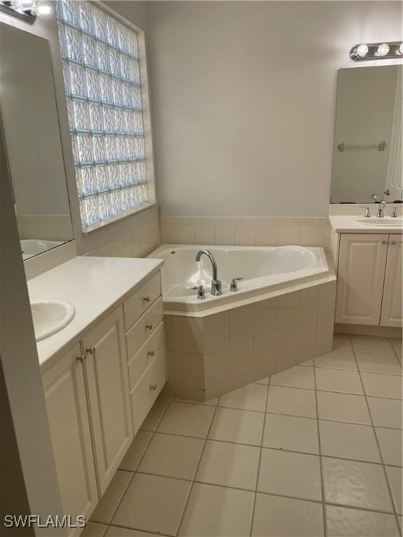 10427 Carolina Willow Dr, Fort Myers, FL 33913 - bathroom with tile patterned floors, two vanities, and a garden tub