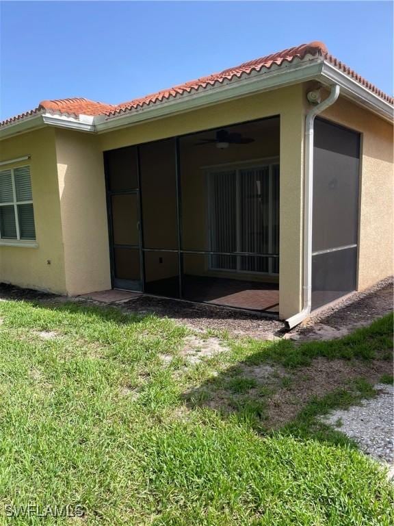 10427 Carolina Willow Dr, Fort Myers, FL 33913 - back of property with a tiled roof, stucco siding, and a sunroom