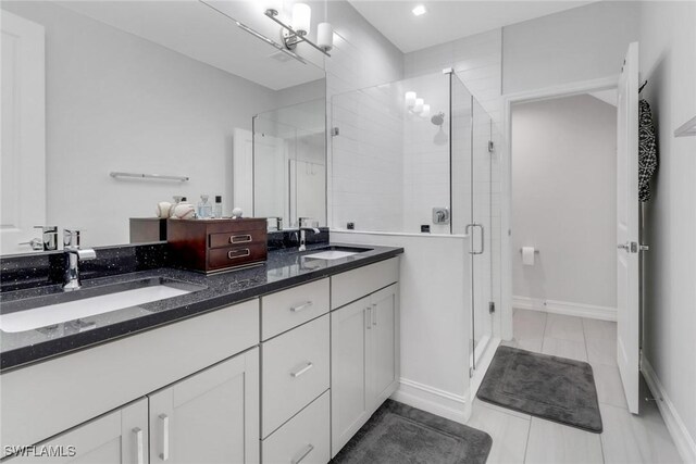 7501 Carnegie Way, Naples, FL 34119 - bathroom with double vanity, a stall shower, baseboards, and recessed lighting