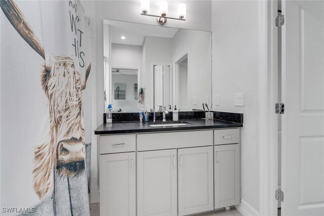 7501 Carnegie Way, Naples, FL 34119 - bathroom featuring vanity, baseboards, and curtained shower