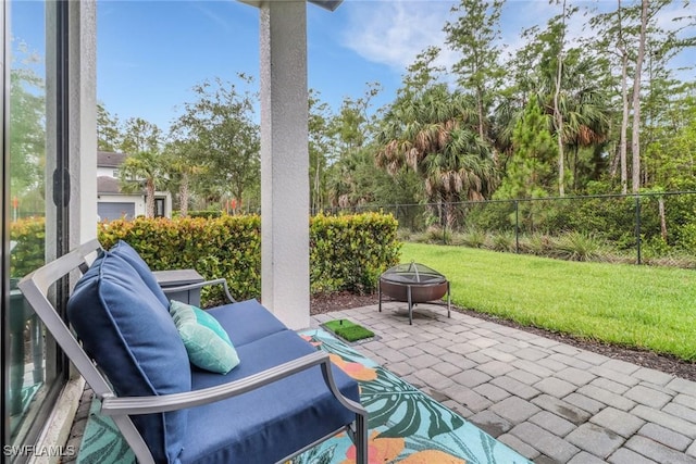 7501 Carnegie Way, Naples, FL 34119 - view of patio / terrace with a fire pit and view of scattered trees