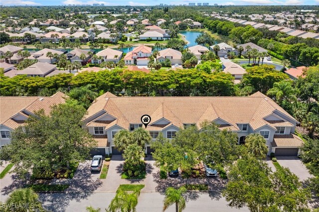 15873 Marcello Cir Unit 76, Naples, FL 34110 - aerial perspective of suburban area with a large body of water