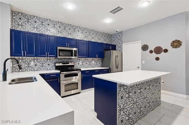 15873 Marcello Cir Unit 76, Naples, FL 34110 - kitchen with stainless steel appliances, a sink, blue cabinets, light marble finish flooring, and recessed lighting