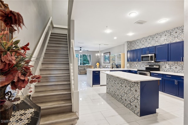 15873 Marcello Cir Unit 76, Naples, FL 34110 - kitchen with blue cabinetry, stainless steel appliances, light countertops, light marble finish floors, and recessed lighting