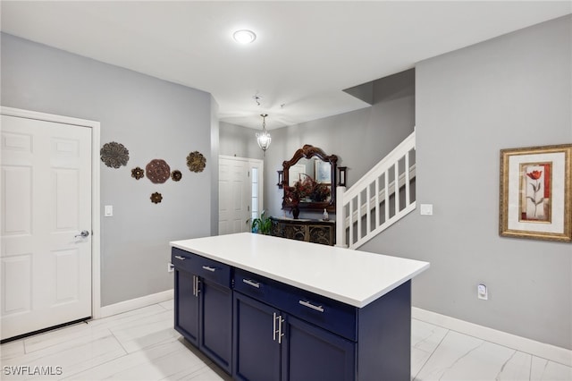 15873 Marcello Cir Unit 76, Naples, FL 34110 - kitchen with blue cabinets, light marble finish floors, and baseboards