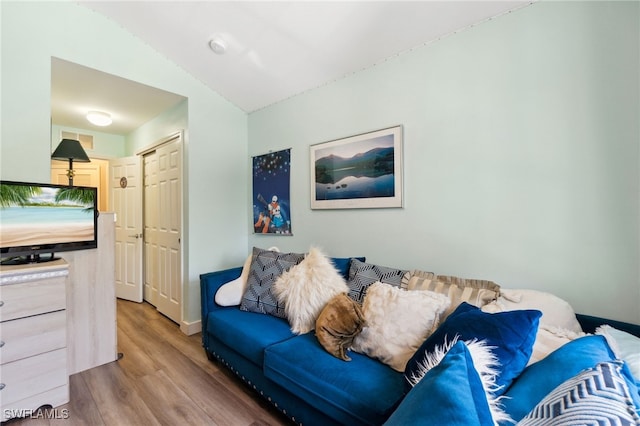 15873 Marcello Cir Unit 76, Naples, FL 34110 - living area with wood finished floors, lofted ceiling, and baseboards