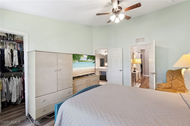 15873 Marcello Cir Unit 76, Naples, FL 34110 - bedroom with a closet, a walk in closet, wood finished floors, and a ceiling fan
