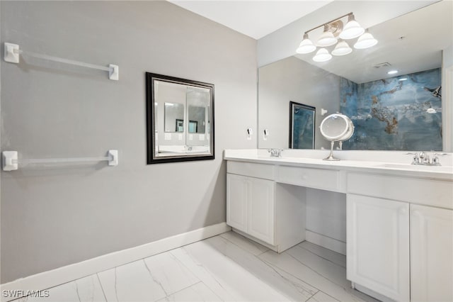15873 Marcello Cir Unit 76, Naples, FL 34110 - bathroom featuring double vanity, marble look tile flooring, and baseboards