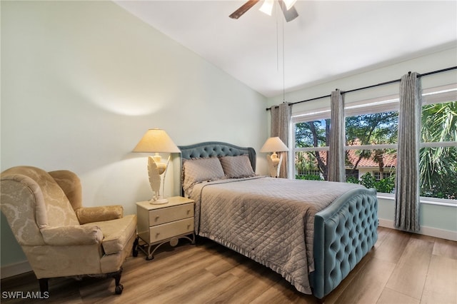 15873 Marcello Cir Unit 76, Naples, FL 34110 - bedroom featuring wood finished floors, baseboards, ceiling fan, and vaulted ceiling