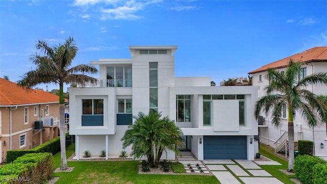 432 Bayside Ave, Naples, FL 34108 - view of front of property featuring stucco siding, a garage, driveway, and a front lawn