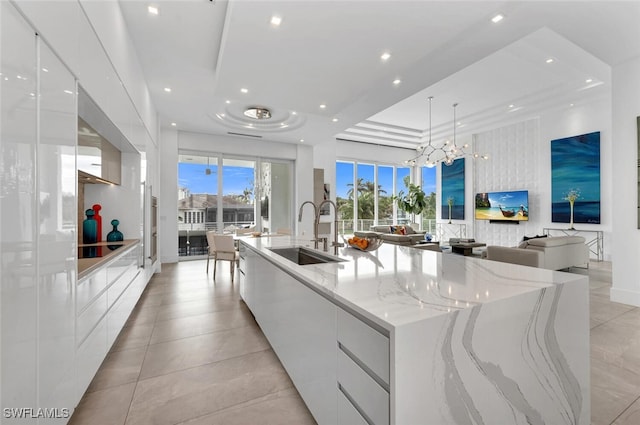 432 Bayside Ave, Naples, FL 34108 - kitchen featuring modern cabinets, white cabinets, a large island with sink, and recessed lighting