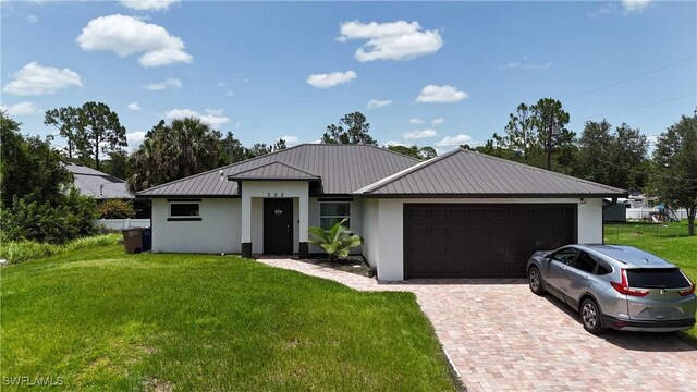 303 E 7th St, Lehigh Acres, FL 33972 - view of front of property with stucco siding, an attached garage, metal roof, and a front yard