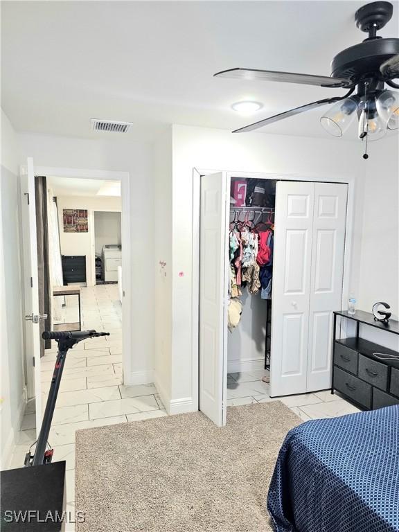 303 E 7th St, Lehigh Acres, FL 33972 - bedroom featuring a closet and baseboards