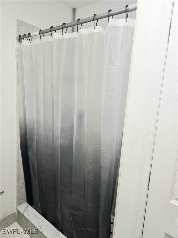 303 E 7th St, Lehigh Acres, FL 33972 - bathroom with a shower with curtain