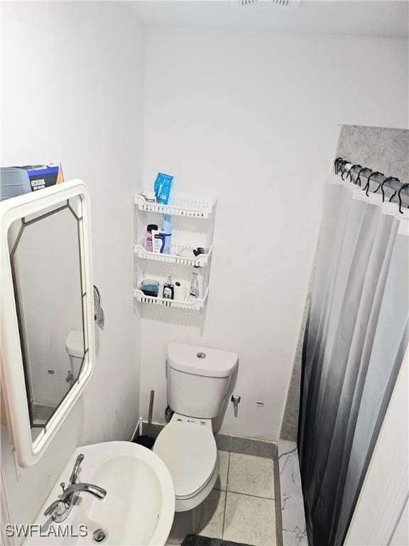 303 E 7th St, Lehigh Acres, FL 33972 - full bathroom with toilet, a sink, and tile patterned floors